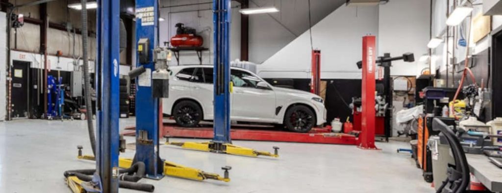 A vehicle getting a four-wheel alignment as part of preventive maintenance