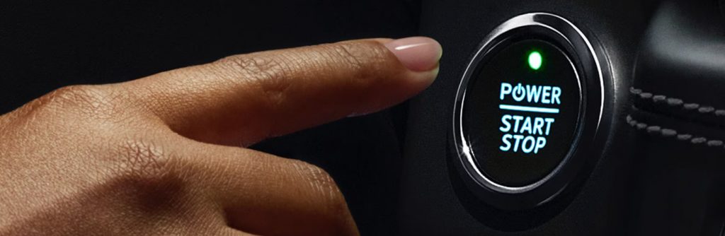 a finger pressing a start button