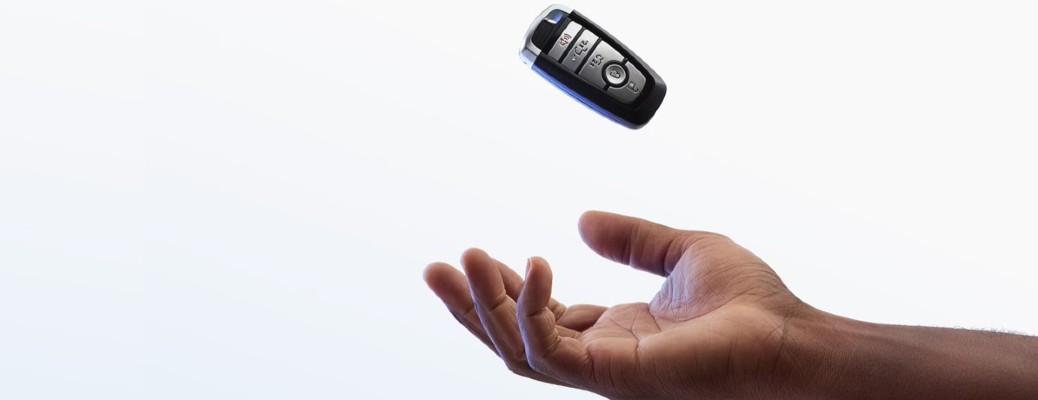 a hand tossing a key into the air