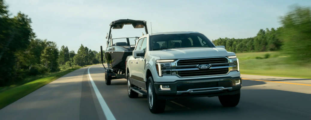 The 2027 Ford F-150 using BlueCruise Towing to tow a large boat