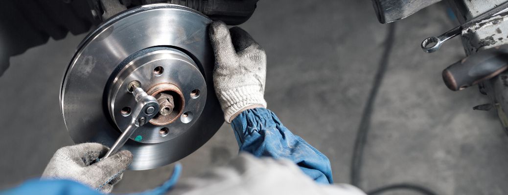 Technician repairing brake of a vehicle