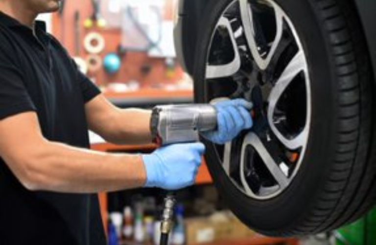 Mechanic working on the vehicle tires