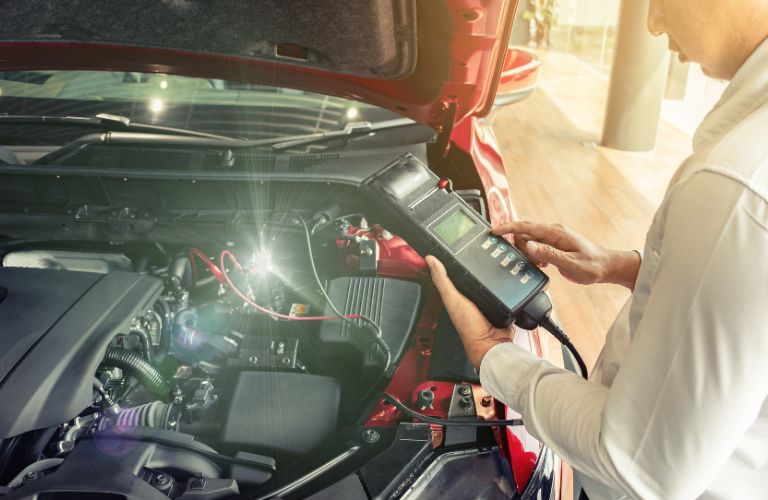 a technician inspecting a battery