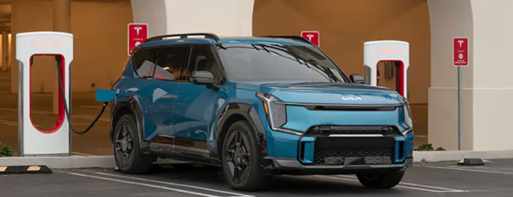 front view of a Kia at a charging station