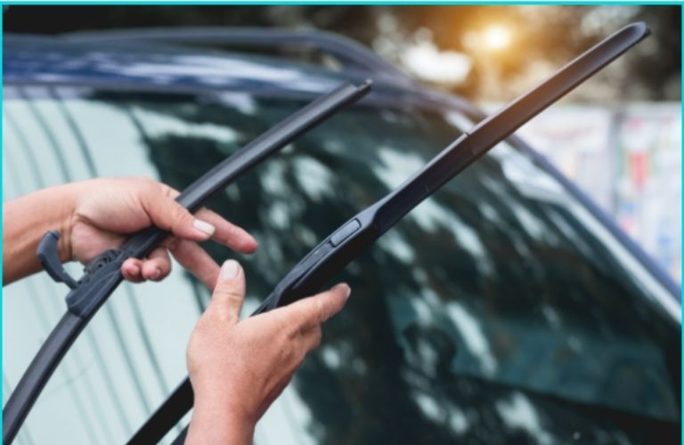 hand holding windshield wiper blades