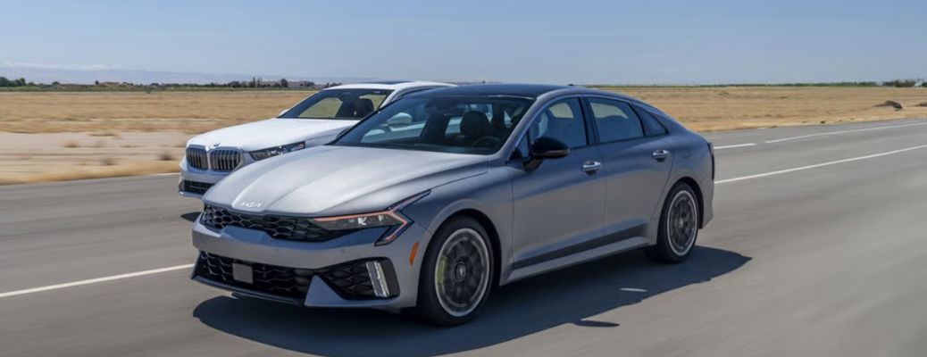 Two 2026 Kia K5 driving side-by-side