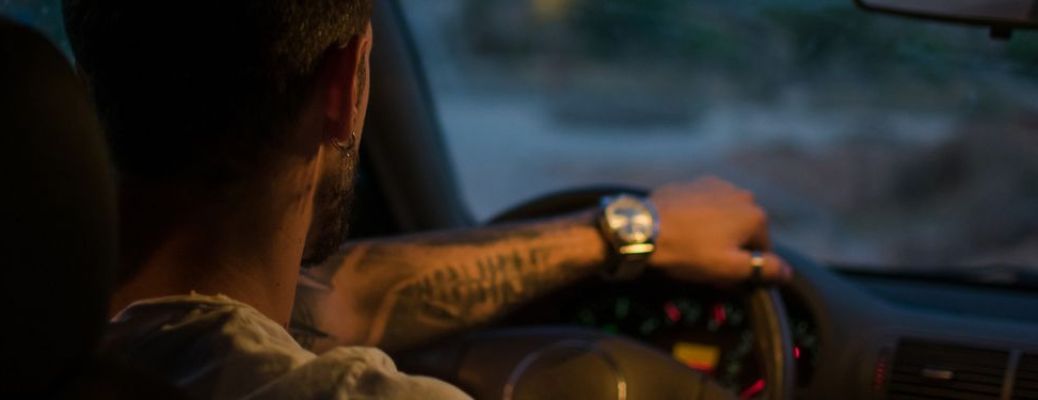 image of a man driving a car