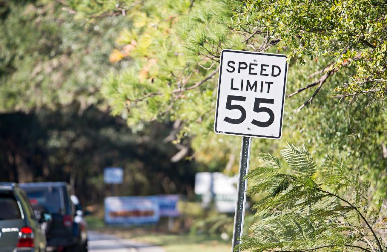 a speed limit board on the road