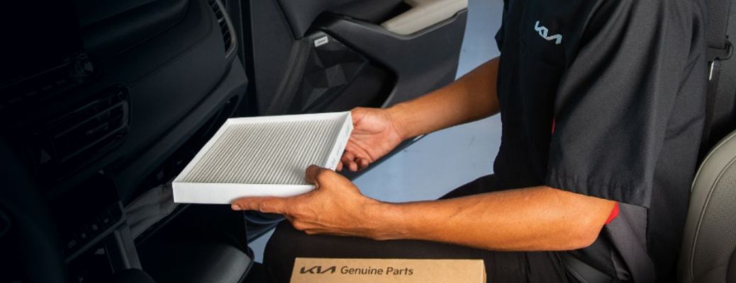 a technician holding genuine Kia cabin air filter