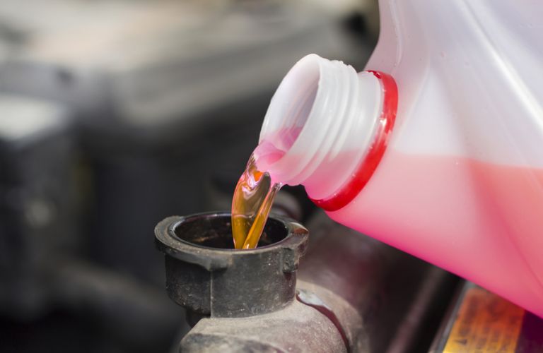 fresh fluid being poured in a car