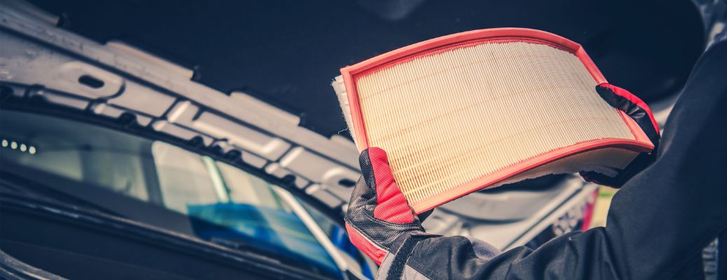 Technician holding a new air filter