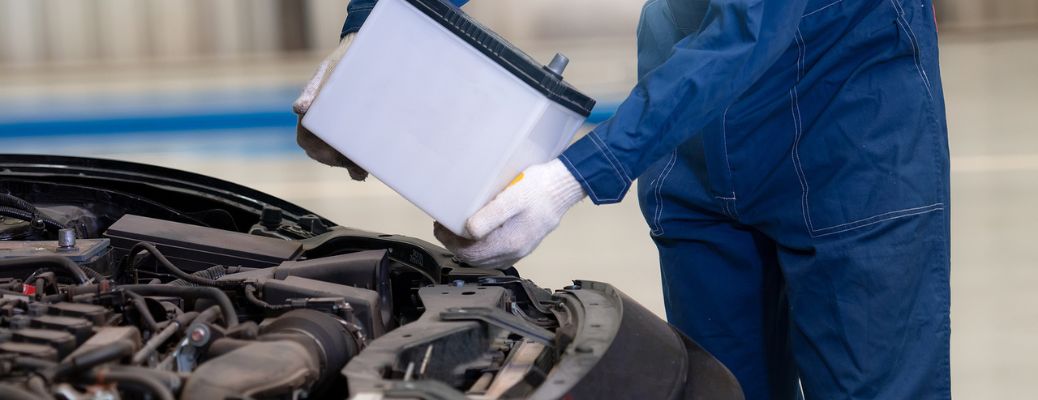 Mechanic replacing a car's battery