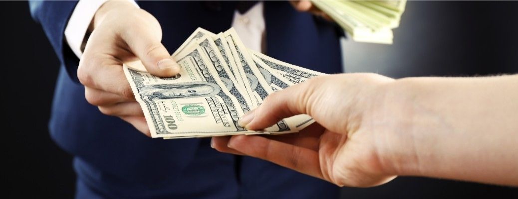 Person handing over cash to another