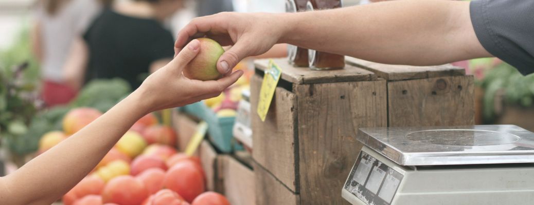 Two hands exchanging fruit