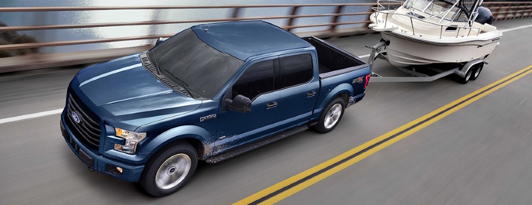 2017 Ford F-150 towing a boat on a road