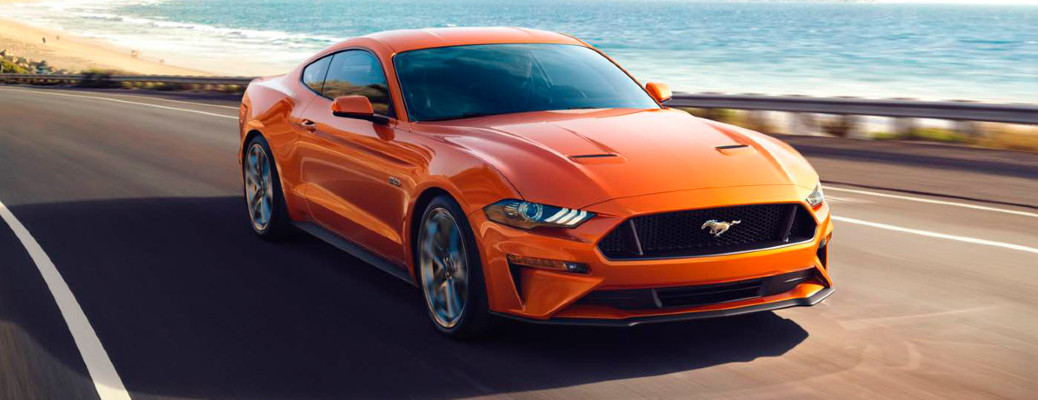 2018 Ford Mustang in orange on a road