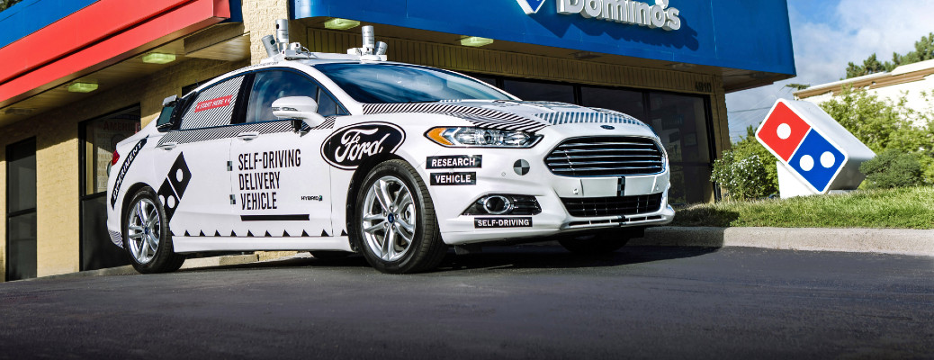 Ford delivery vehicle by a building