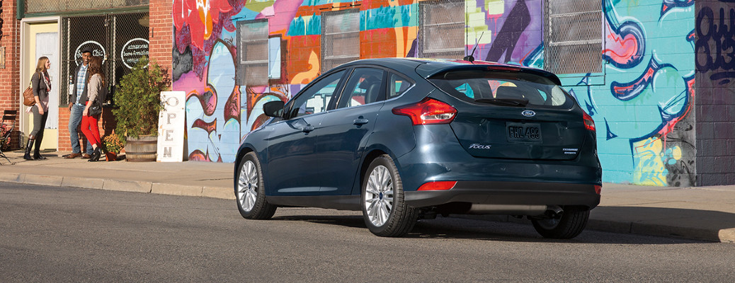 2018 Ford Focus rear view in front of street art