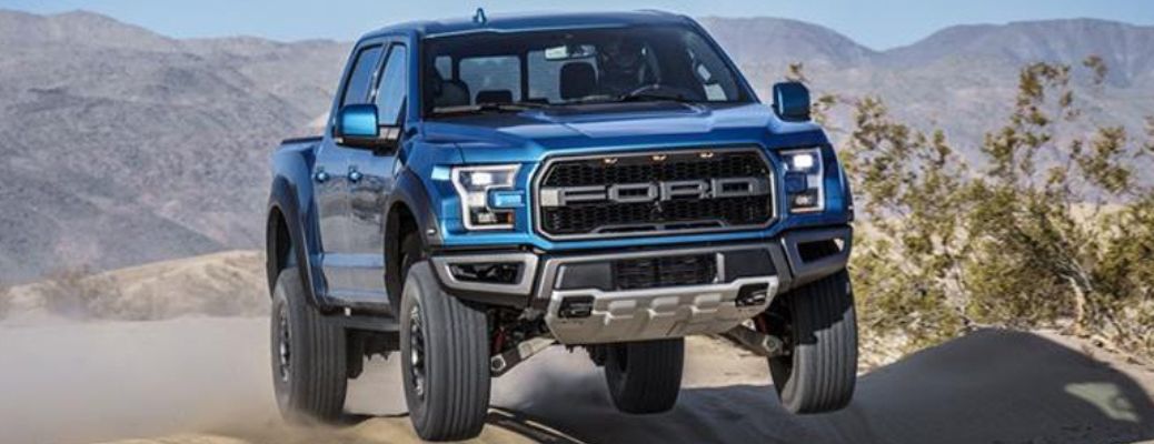 2019 Ford F-150 Raptor truck front view in sand