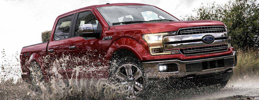 2018 Ford F-150 truck driving in mud