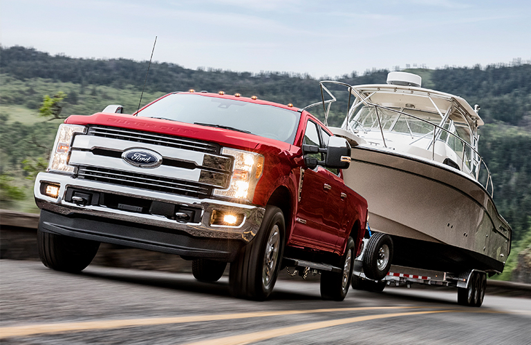 2019 Ford Super Duty in red towing a boat