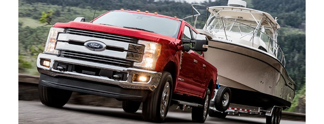 2019 Ford Super Duty in red towing a boat