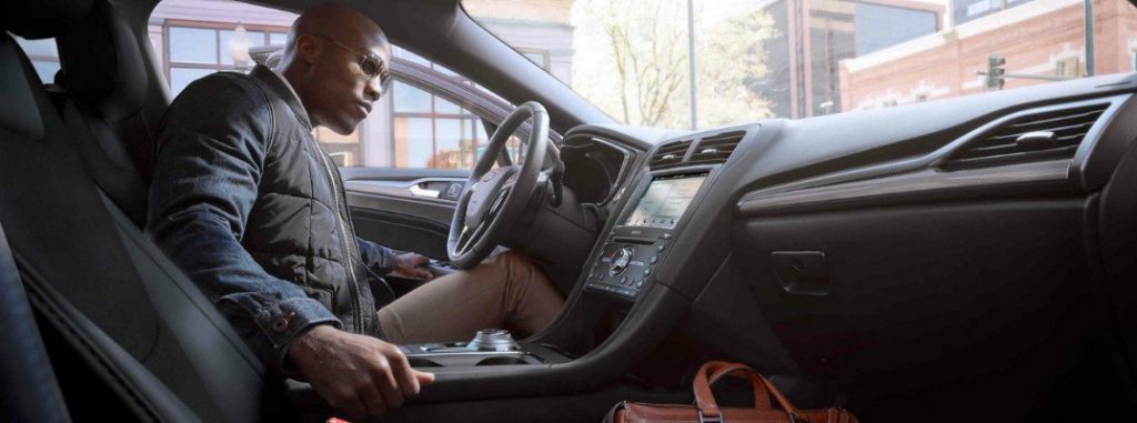 Man using Push Button Start inside 2019 Ford Fusion