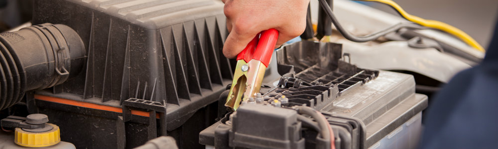 Using jumper cables to jump start a Ford battery