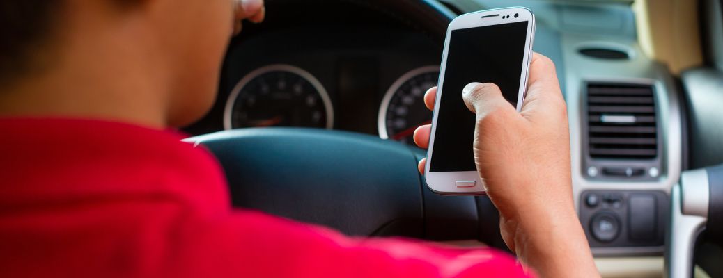 person wearing a red shirt holding a white phone