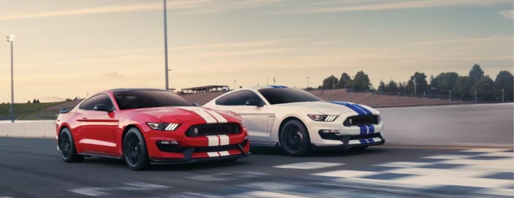 red and white Ford Mustang Shelby models on a track