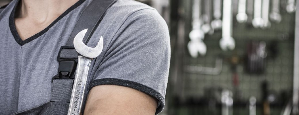 the shoulder of a person carrying a wrench