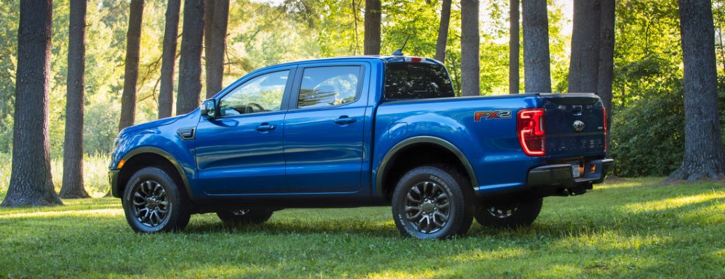2020 Ford Ranger side view with blue paint in a forest