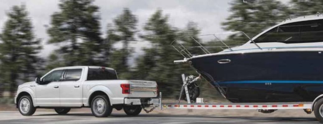 white 2020 Ford F-150 towing a boat