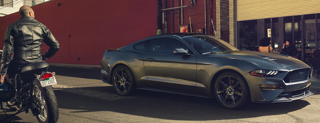 2020 Ford Mustang side view by a biker