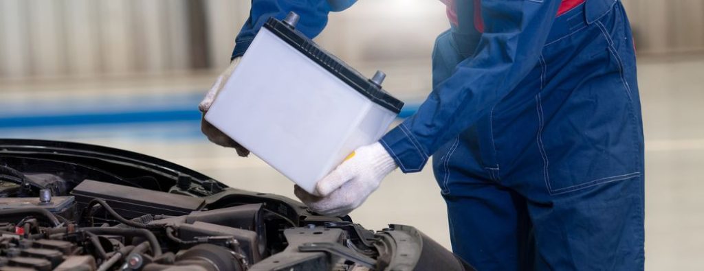 a person holding a battery wearing white gloves