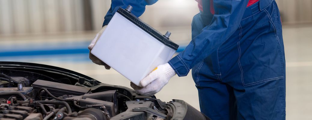 a person holding a battery wearing white gloves