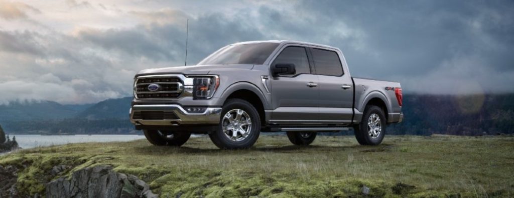 2021 Ford F-150 front and side view by water on grass
