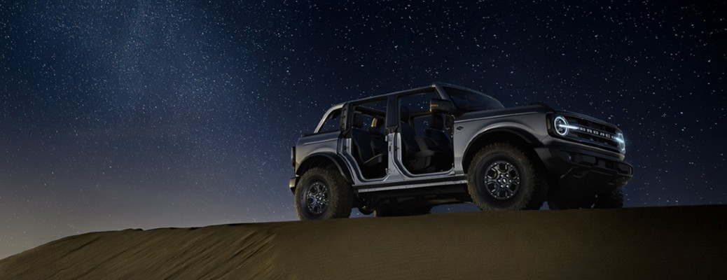 2021 Ford Bronco side view at night on a hill