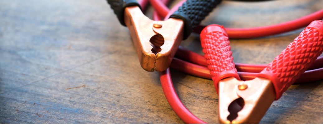 jump-starting cables lying on a flat surface