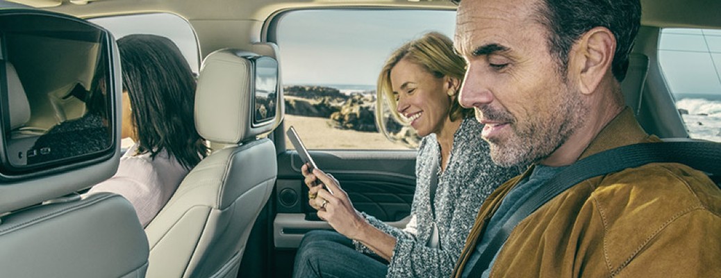 2020 Ford Expedition Limited with two passengers on their phones