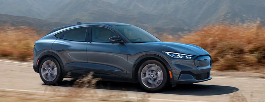 2021 Ford Mustang Mach-E Premium side view on a dirt road