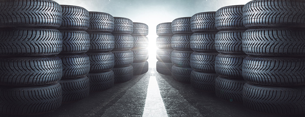 tire in stacks around an aisle with light at the end