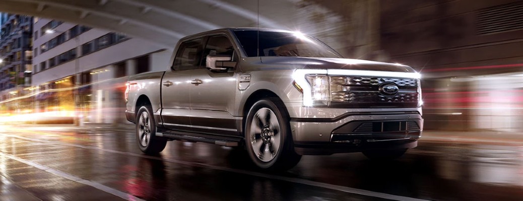 2022 Ford Lightning XLT driving in a dark city