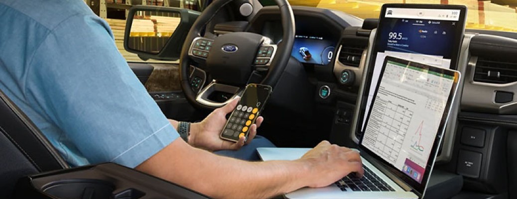 2022 Ford F-150 Lightning XLT front seats with laptop and phone inside