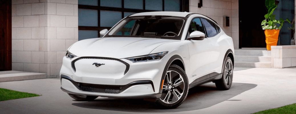 2022 Ford Mustang Mach-E EV parked by a garage