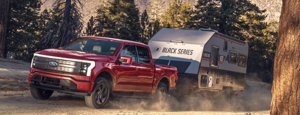 2023 Ford F-150 Lightning driving in snow with a trailer