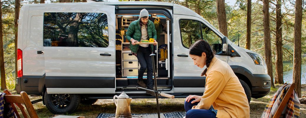 2023 Ford Transit Trail Van with people at a campsite