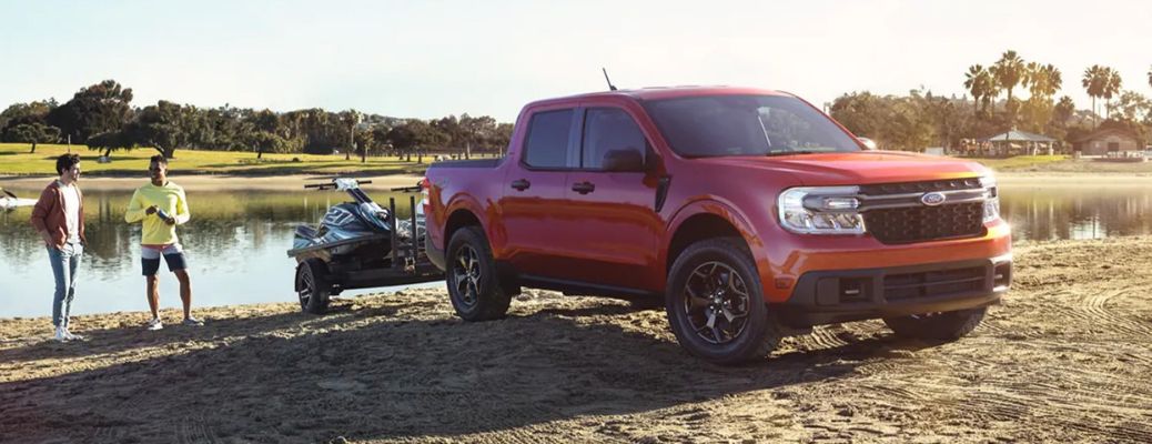 Ford Maverick by a lake with two people