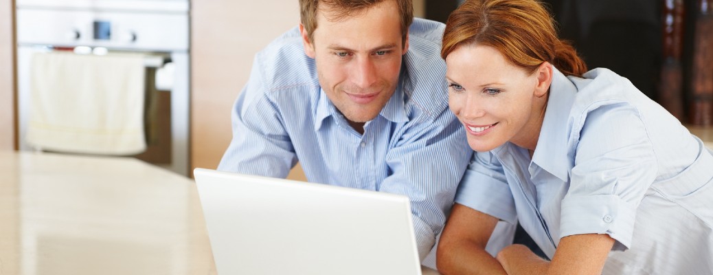 two people looking at a laptop together