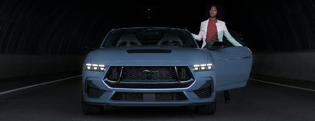 2024 Ford Mustang Dark Horse with a person standing next to it